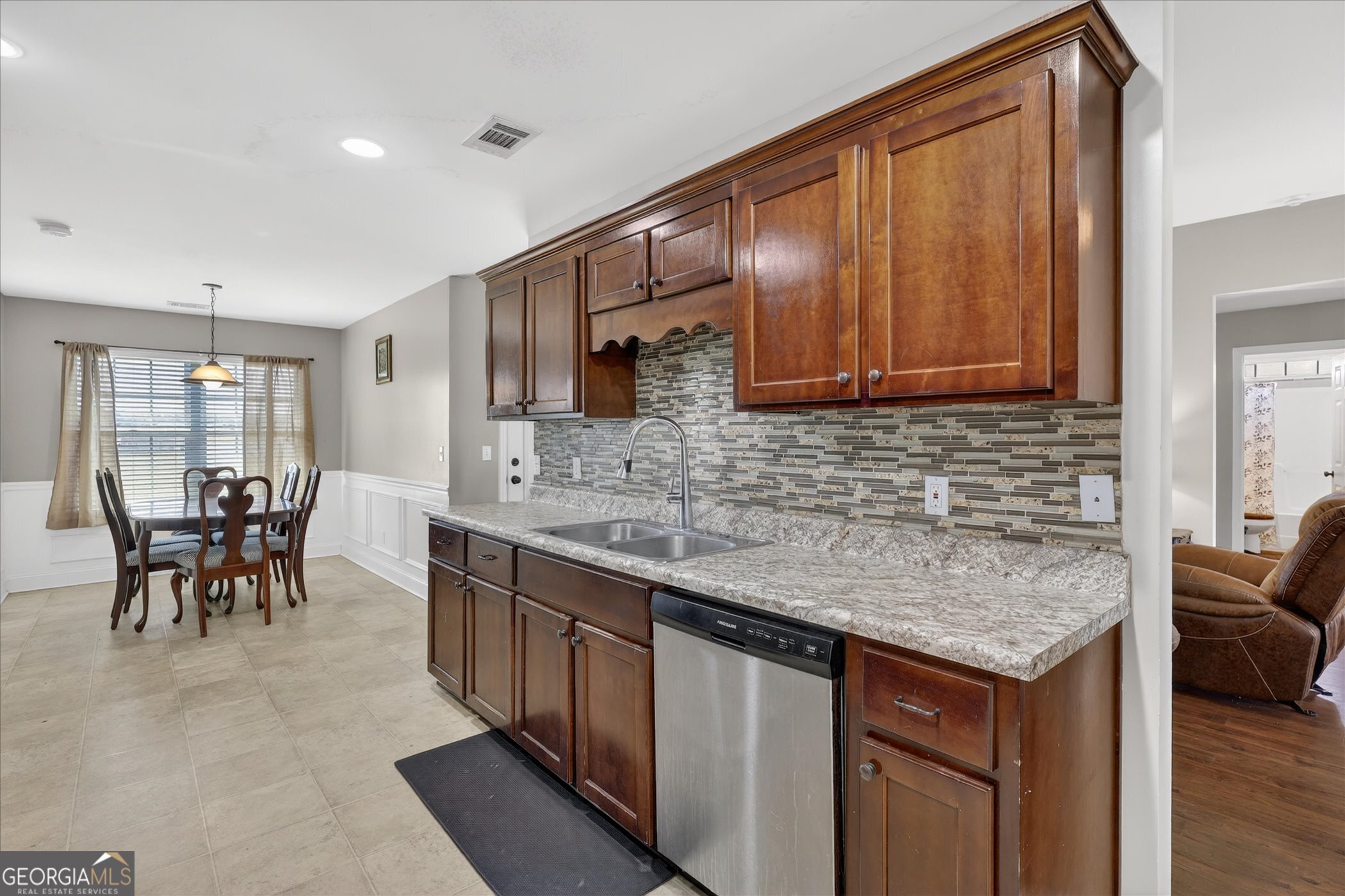 245 Stonebrook Way Statesboro, GA 30458 - Photo 22 of 32 a kitchen with granite countertop sink cabinets and stainless steel appliances