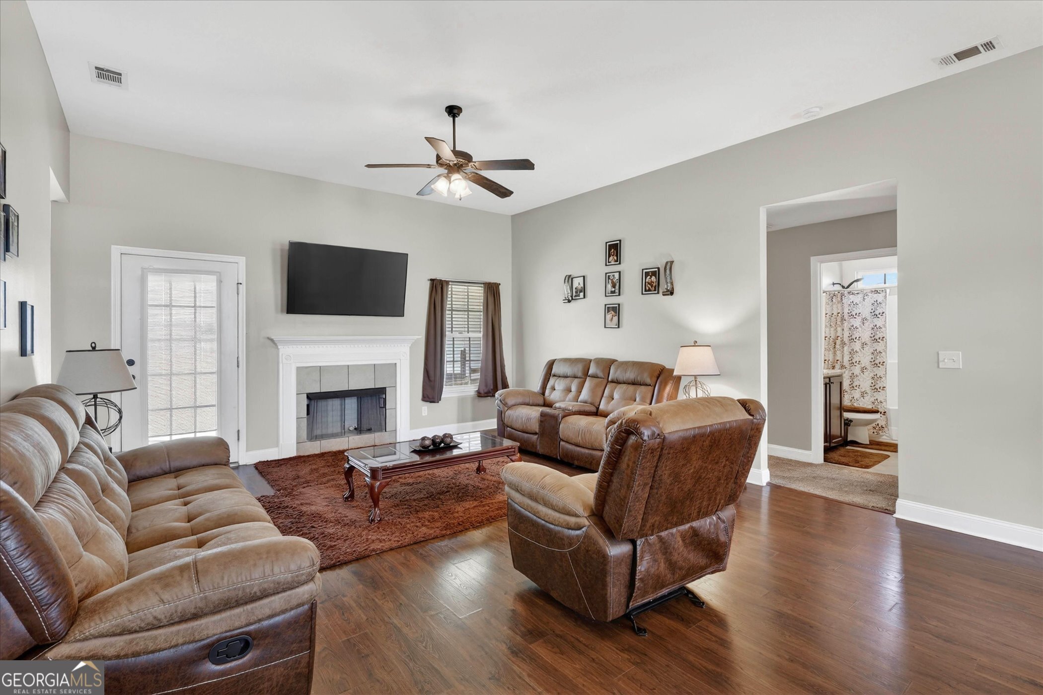 245 Stonebrook Way Statesboro, GA 30458 - Photo 7 of 32 a living room with furniture a fireplace and a flat screen tv