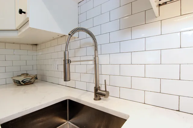a living room with furniture a wooden floor and white walls