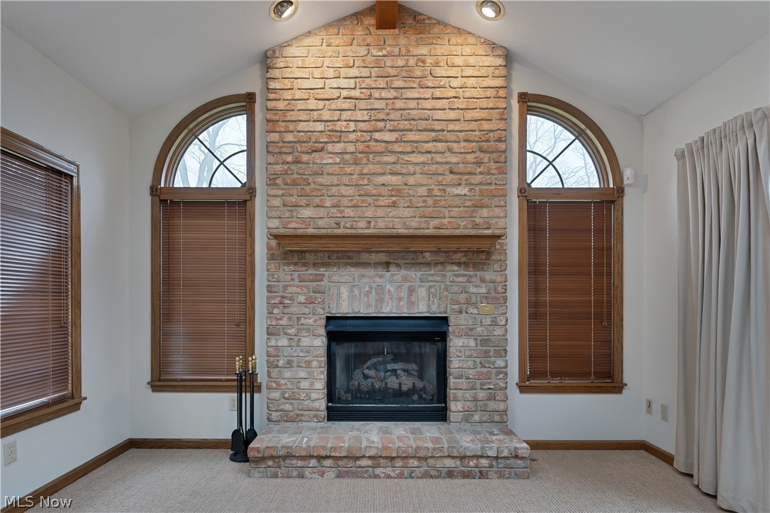 6599 Struthers Road Youngstown, OH 44514 - Photo 16 of 29 Unfurnished living room featuring carpet and a brick fireplace