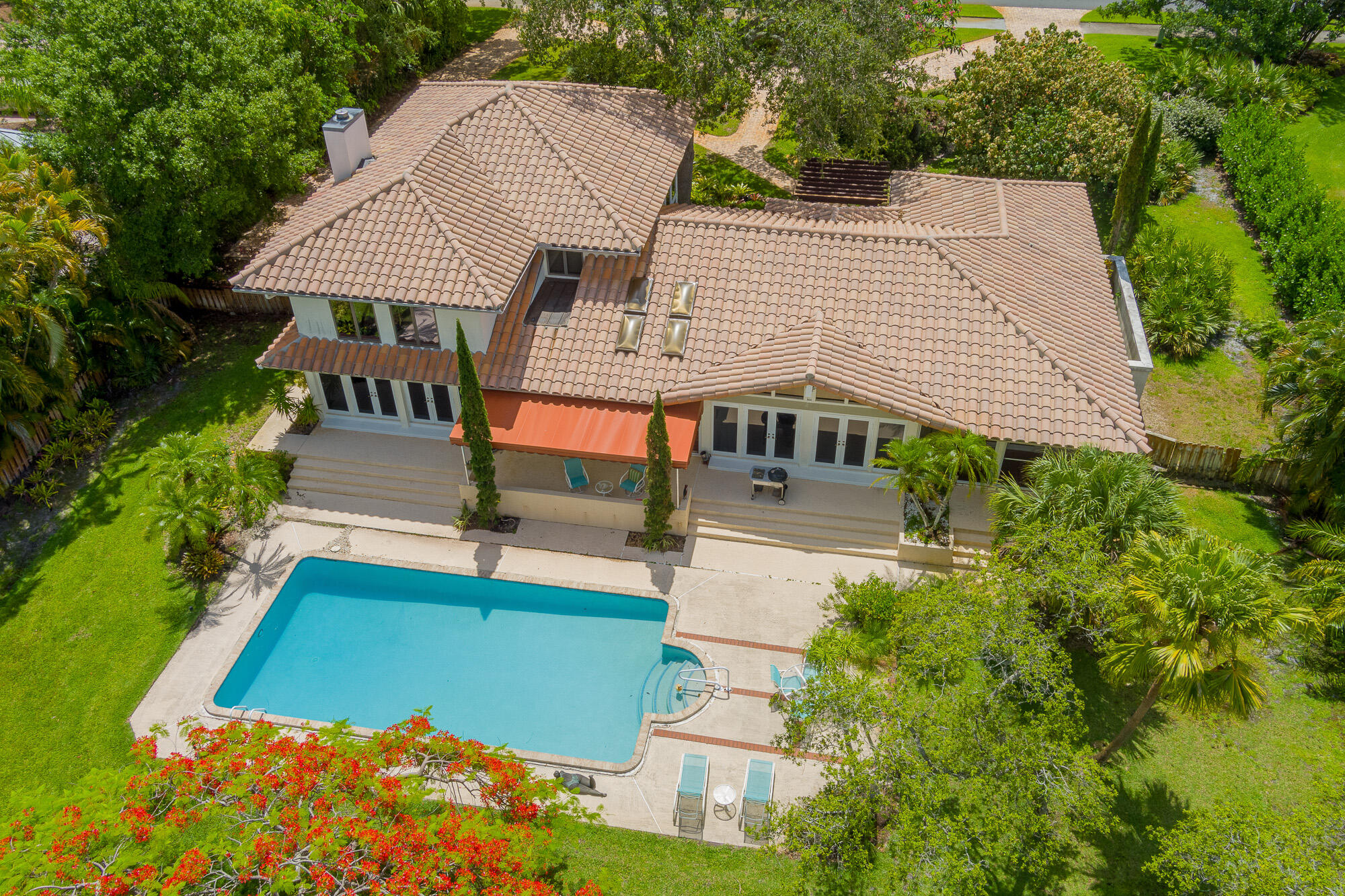 a aerial view of a house with swimming pool and sitting area