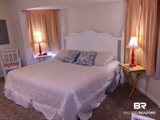 8749 Pompano Way Gulf Shores, AL 36542 - Photo 18 of 45 master bedroom has architectural extension behind the bed.