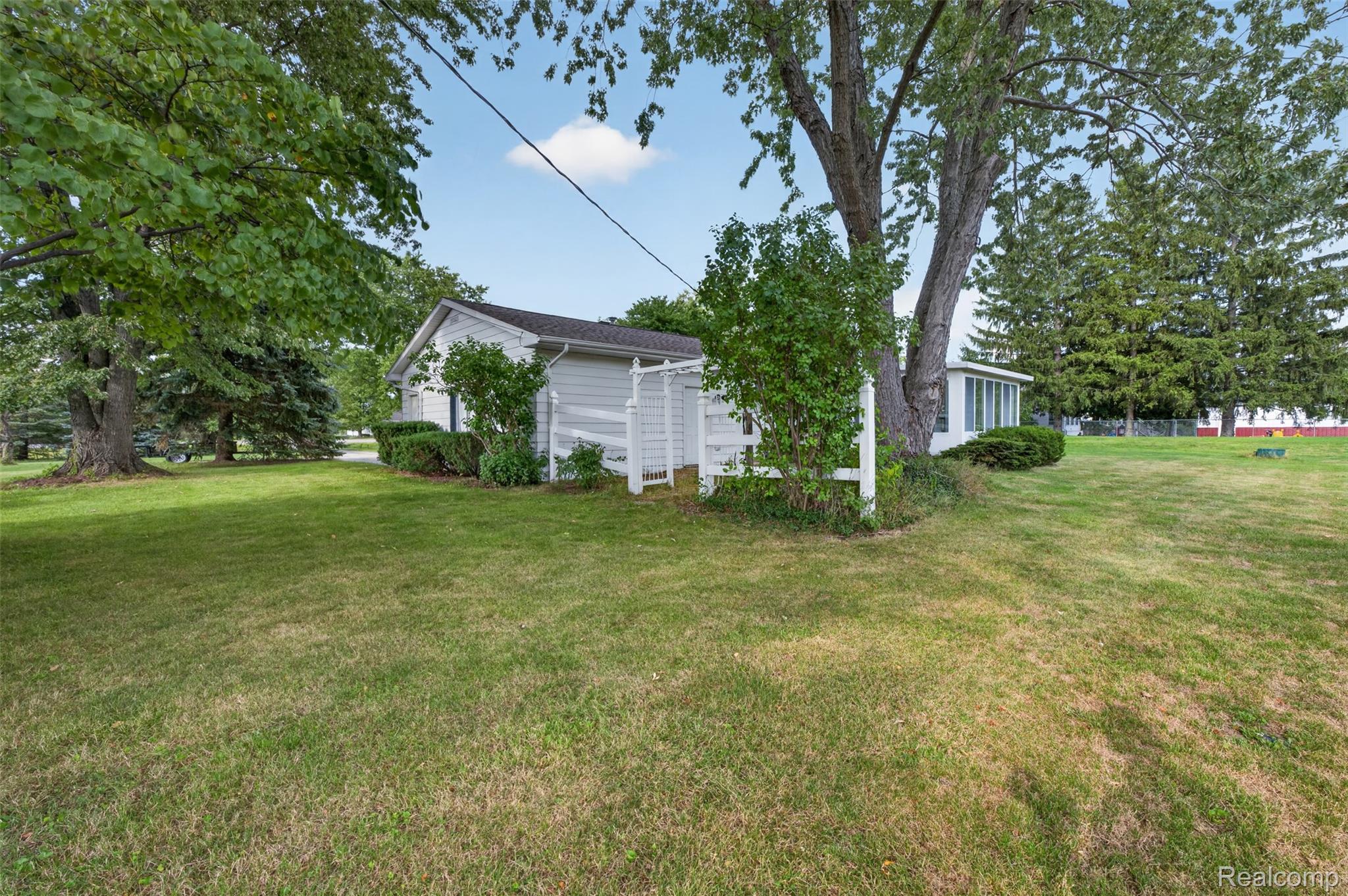 12055 West Pierson Road Flushing, MI 48433 - Photo 53 of 69 Expansive lawn area with mature trees and established landscaping