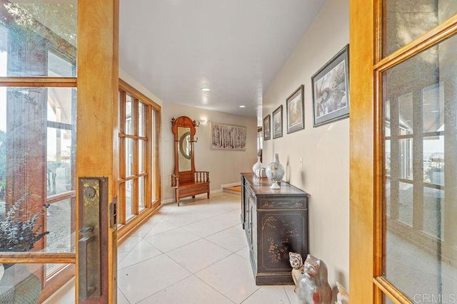 a living room with furniture fireplace and a large window