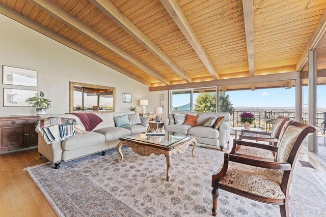 a living room with furniture and large windows