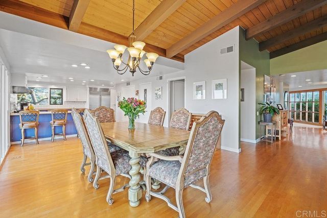 a spacious bedroom with a bed and glass walk in closet