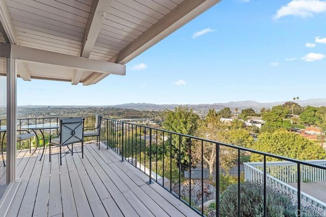 a living room with furniture large window and a fireplace