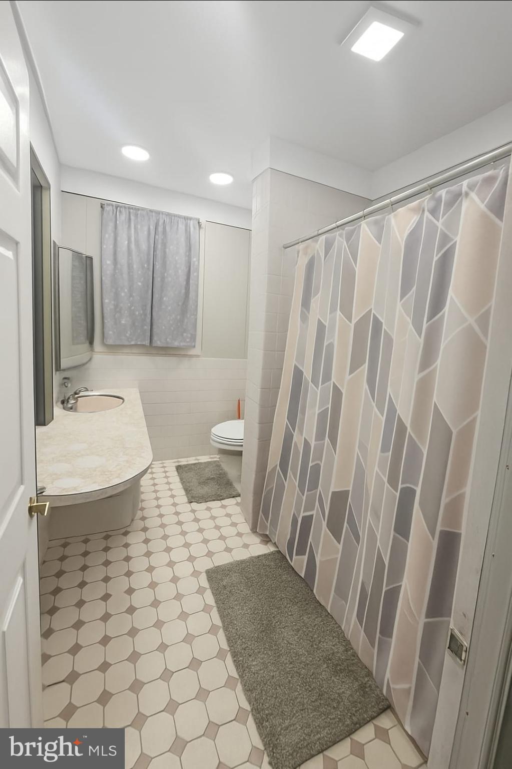 2622 Perkiomen Avenue Reading, PA 19606 - Photo 16 of 27 a bathroom with a sink a toilet a shower and a mirror