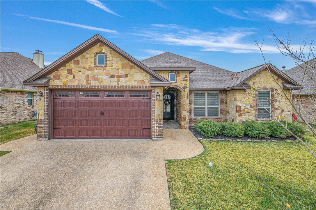 3049 Embers Loop Bryan, TX 77808 - Photo 1 of 21 a view of a house with a yard and garage