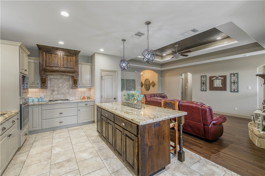 3049 Embers Loop Bryan, TX 77808 - Photo 12 of 21 a kitchen with granite countertop a sink stove and cabinets