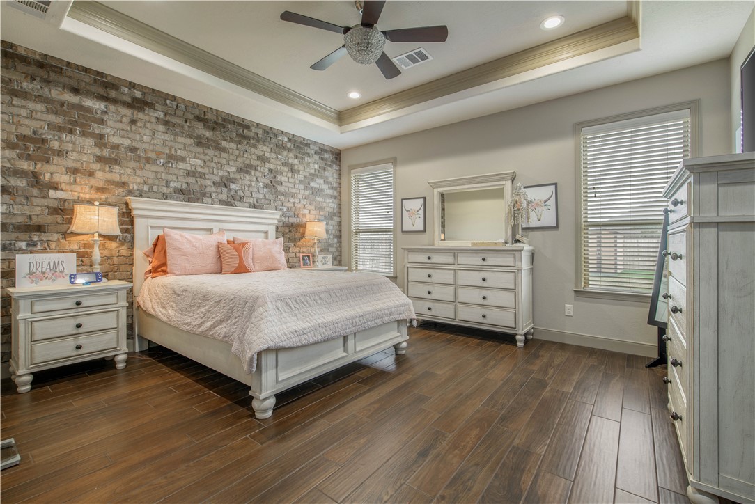3049 Embers Loop Bryan, TX 77808 - Photo 13 of 21 a bedroom with a bed and a dresser