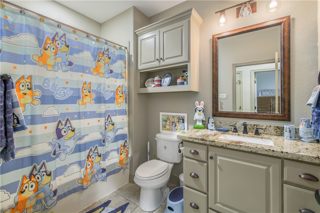 3049 Embers Loop Bryan, TX 77808 - Photo 16 of 21 a bathroom with a sink mirror vanity and toilet
