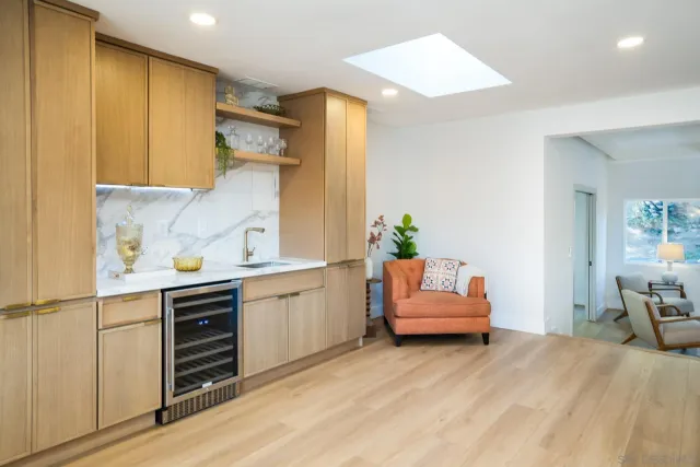 a hallway with a couch and dresser with wooden floor