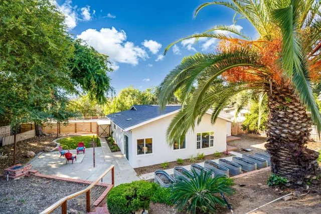 a view of a backyard with wooden fence