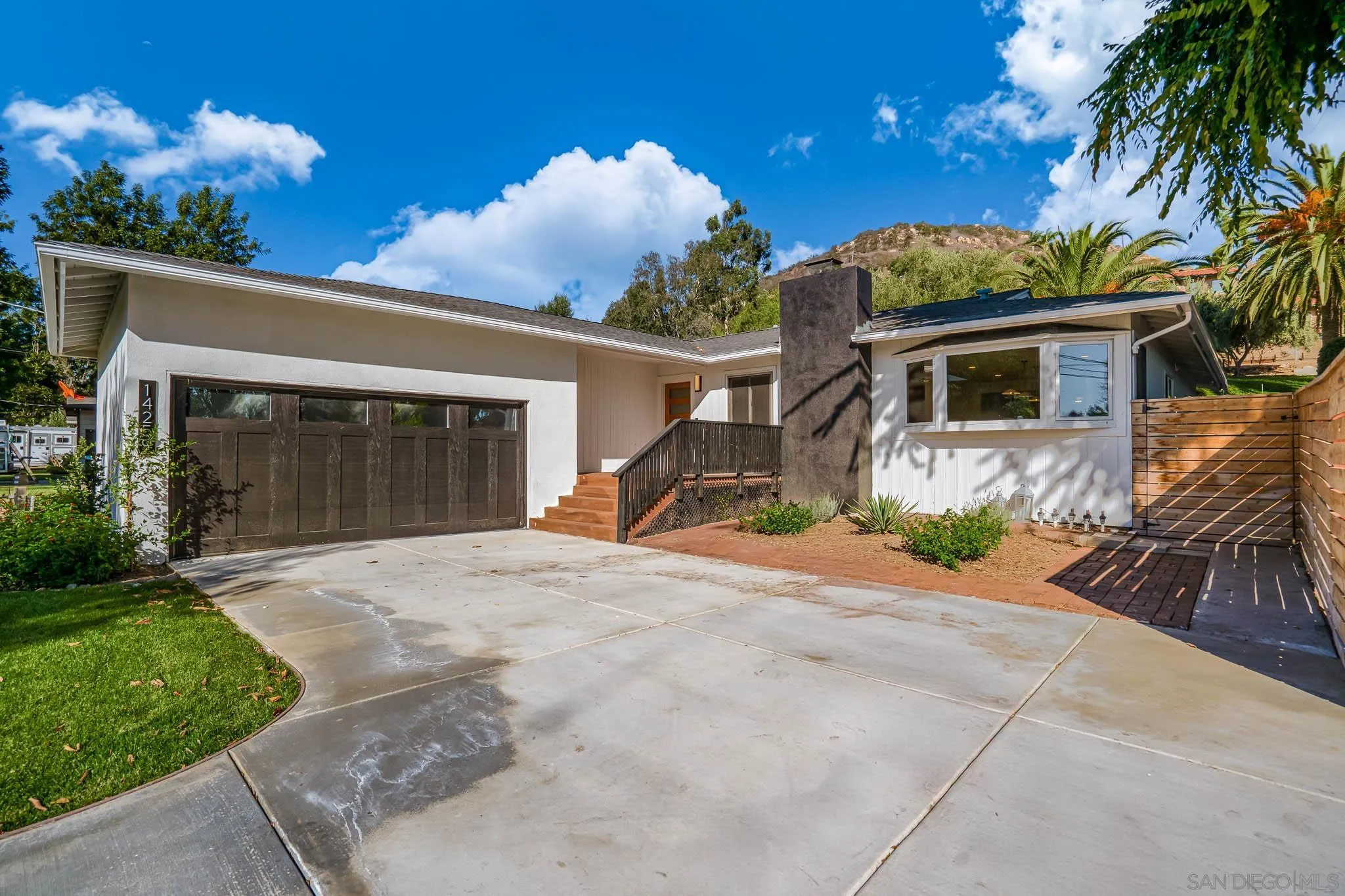 14259 Midland Road Poway, CA 92064 - Photo 44 of 60 a front view of a house with a yard and a garage