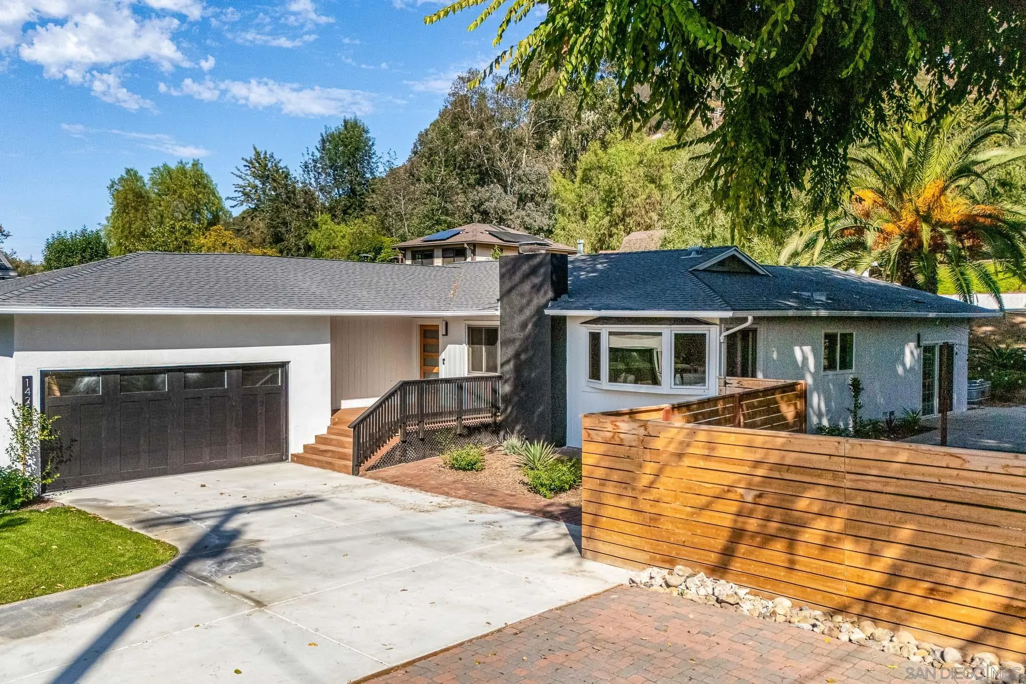 14259 Midland Road Poway, CA 92064 - Photo 53 of 60 a front view of a house with a yard and garage