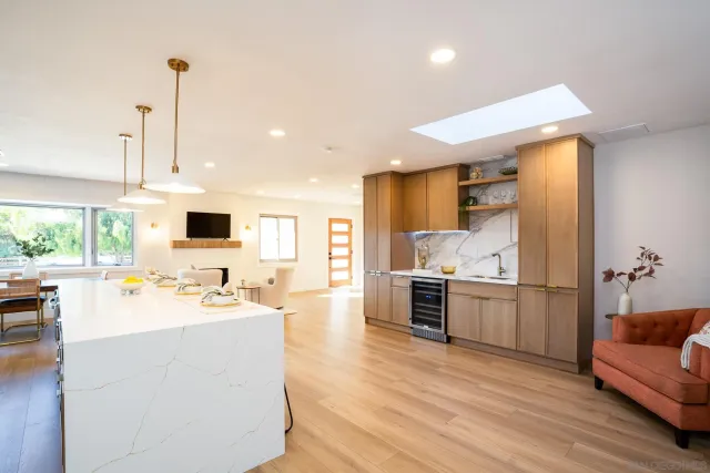 a kitchen with kitchen island sink stove and refrigerator