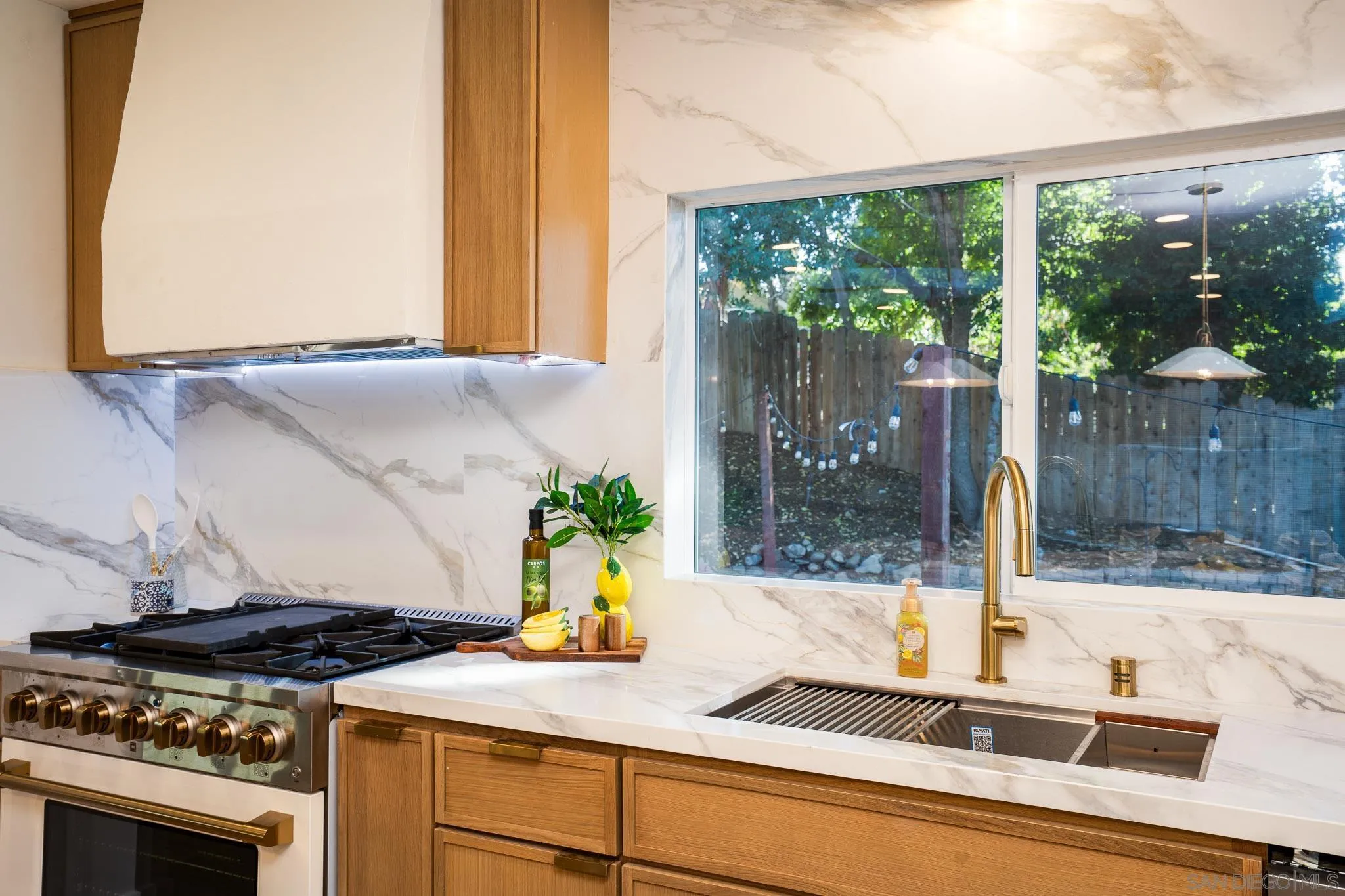 14259 Midland Road Poway, CA 92064 - Photo 9 of 60 a kitchen with a sink and a stove next to a window