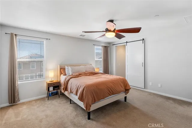 an empty room with closet and windows