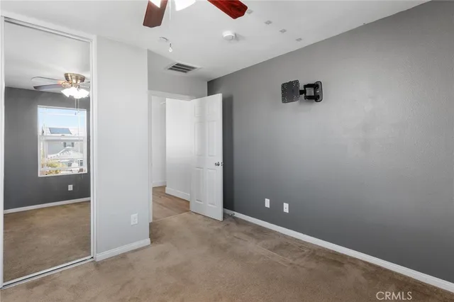 a living room with furniture a flat screen tv and a window