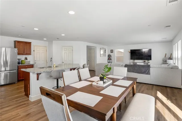 a kitchen with stainless steel appliances granite countertop a refrigerator stove and sink