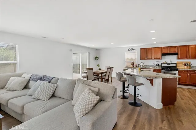 a kitchen with stainless steel appliances granite countertop a sink stove and cabinets