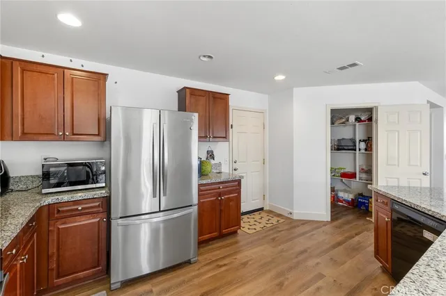 a view of a patio with table and chairs potted plants with wooden fence