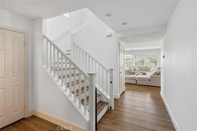 a view of a hallway view with wooden floor and staircase