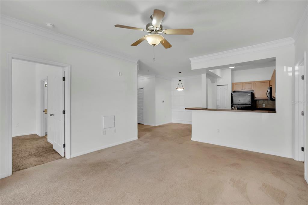 12831 Madison Pointe Circle, Unit 107 Orlando, FL 32821 - Photo 4 of 11 a view of a livingroom with a kitchen