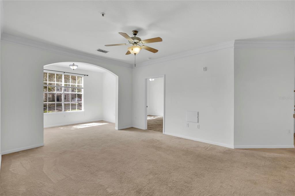 12831 Madison Pointe Circle, Unit 107 Orlando, FL 32821 - Photo 6 of 11 a view of an empty room with a window