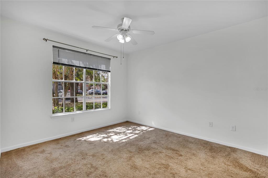 12831 Madison Pointe Circle, Unit 107 Orlando, FL 32821 - Photo 7 of 11 an empty room with a window
