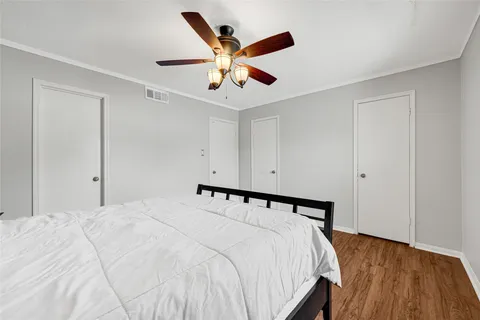 a bedroom with a bed and ceiling fan