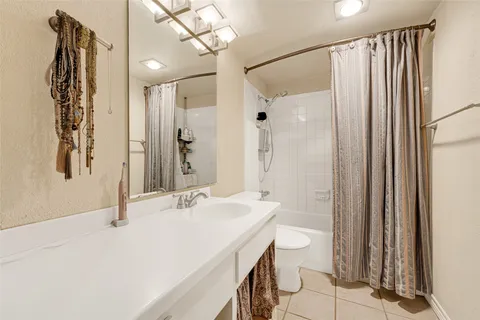 a bathroom with a sink and mirror with toilet