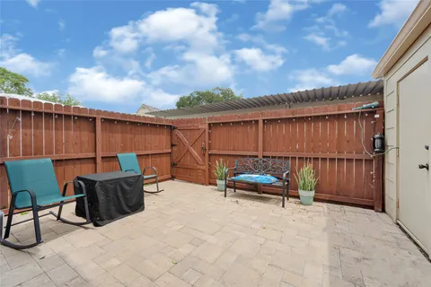a view of patio with a table and chairs