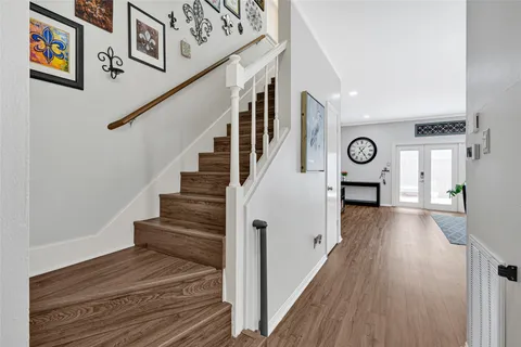 a view of entryway and hall with wooden floor
