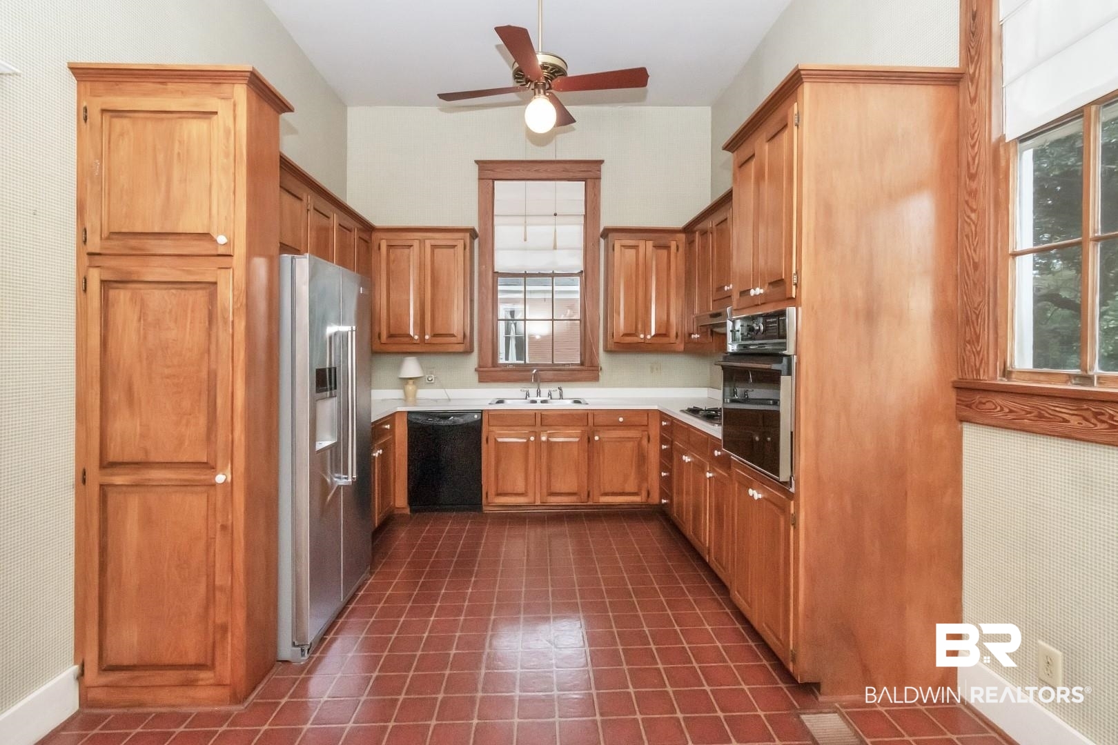 959 Dauphin Street Mobile, AL 36604 - Photo 10 of 43 Kitchen with dark tile patterned floors, black appliances, sink, and ceiling fan