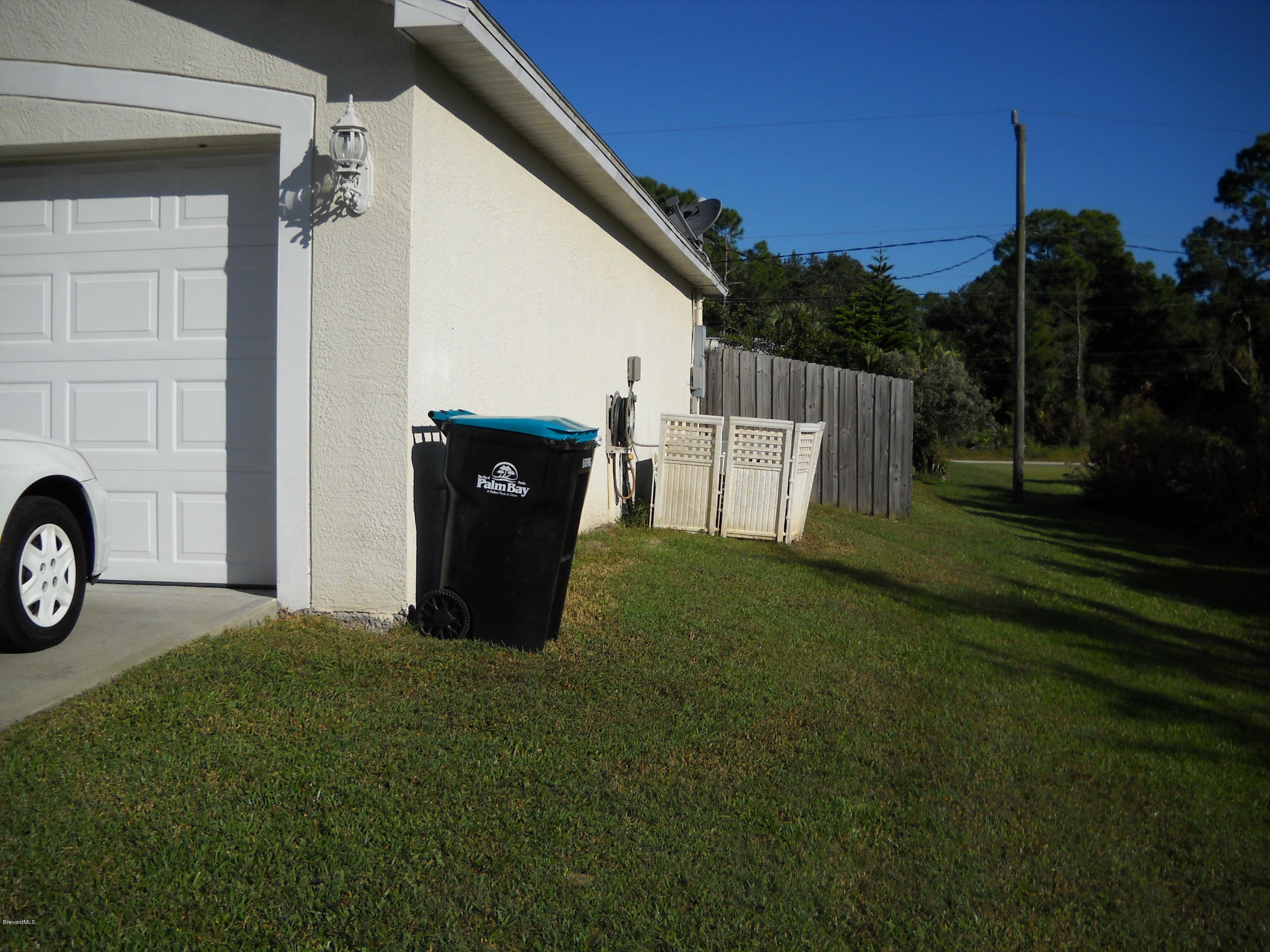731 Schuster Road Southwest Palm Bay, FL 32908 - Photo 2 of 14 East side showing fence