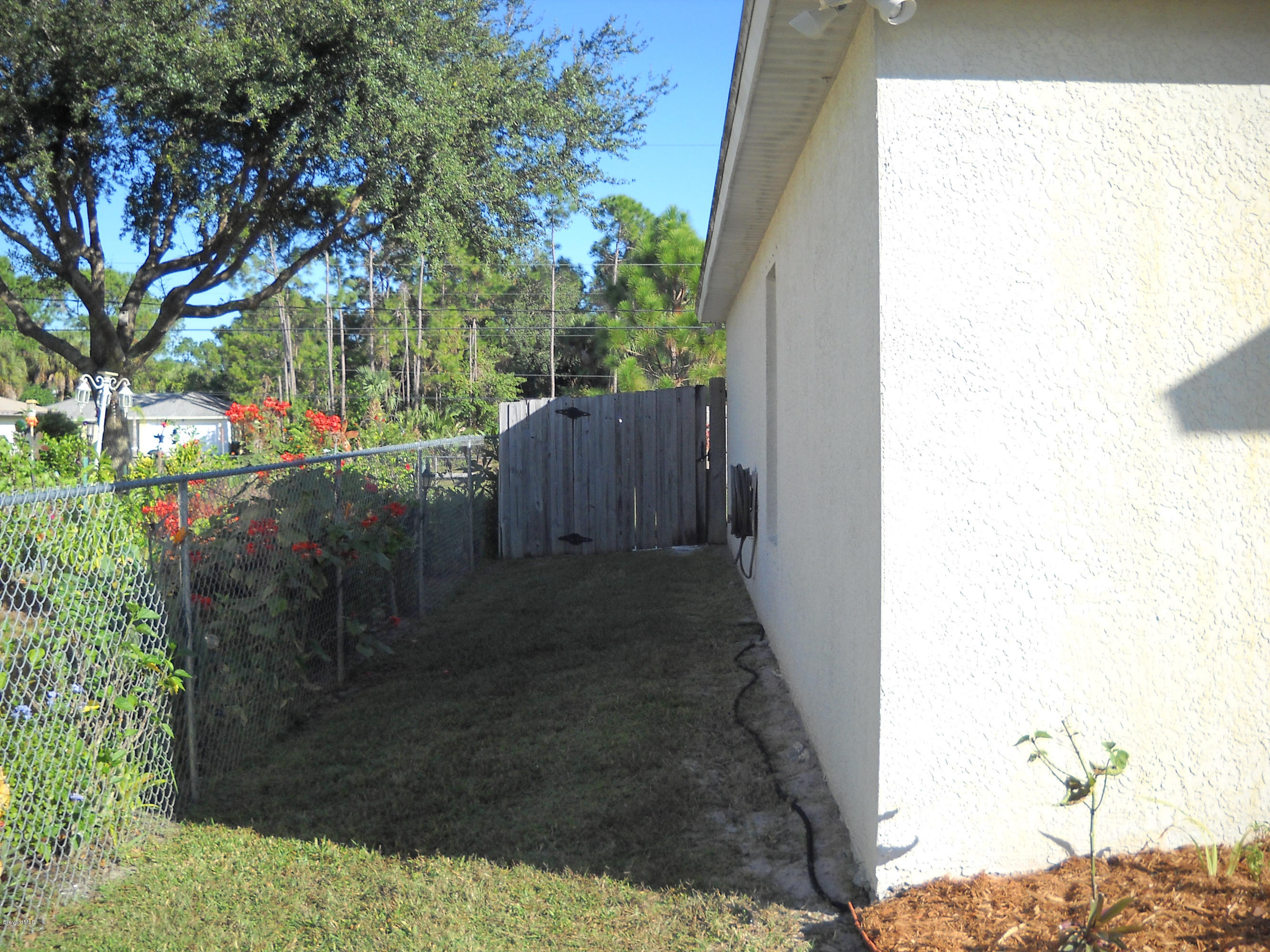 731 Schuster Road Southwest Palm Bay, FL 32908 - Photo 3 of 14 West side showing fence