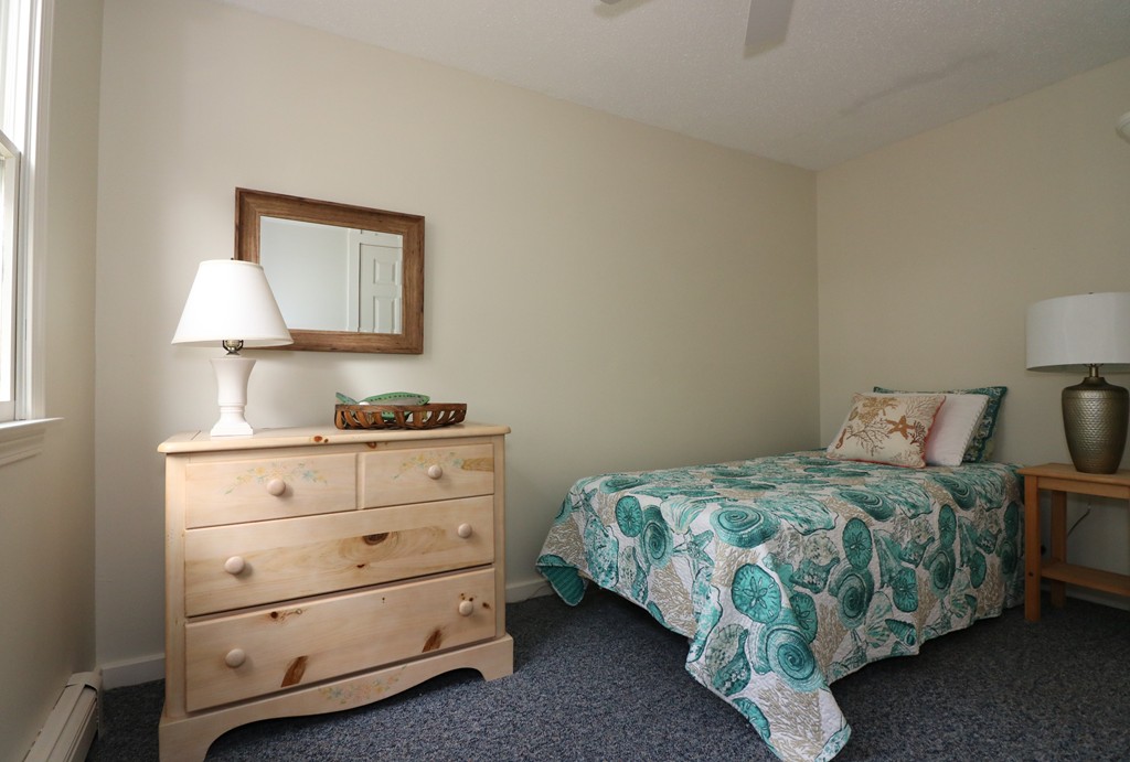 36 Ide-Ho Lane Eastham, MA 02642 - Photo 17 of 30 a bedroom with a bed and a lamp on dresser