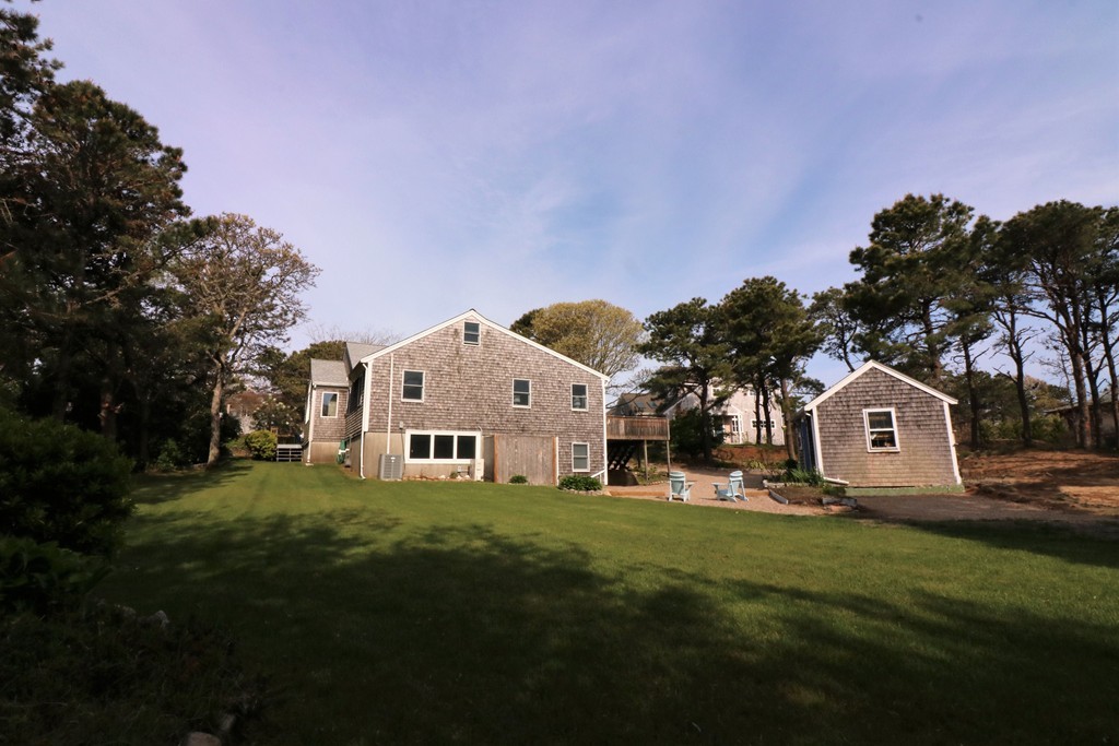 36 Ide-Ho Lane Eastham, MA 02642 - Photo 26 of 30 a front view of a house with a garden and trees