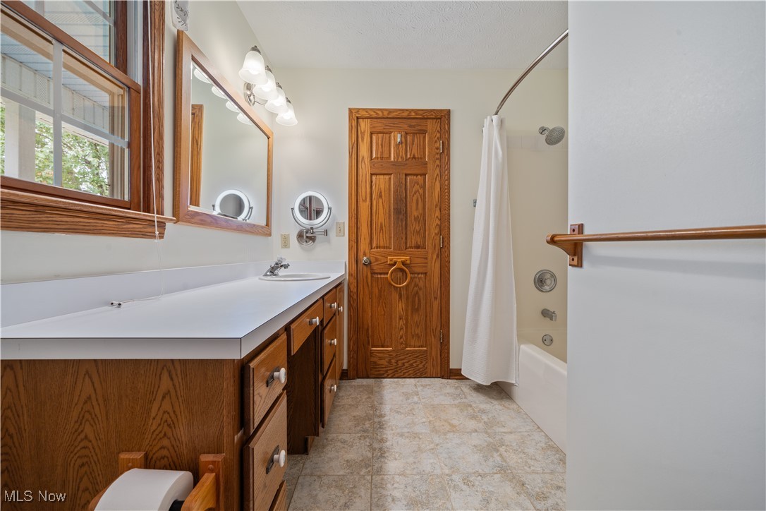 891 Station Road Valley City, OH 44280 - Photo 22 of 45 Bathroom with vanity, shower / bath combo with shower curtain, and tile patterned floors