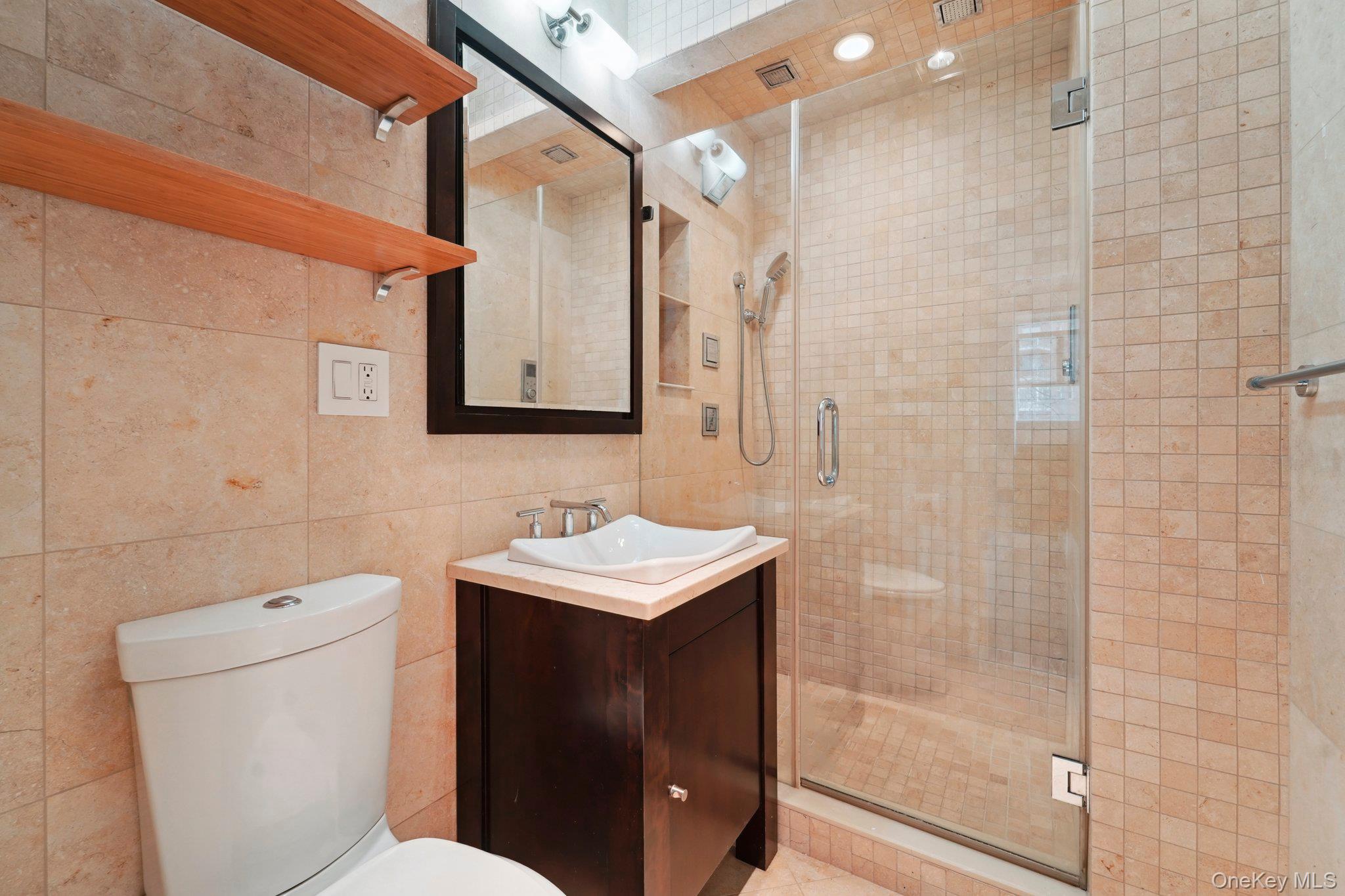 2727 Palisade Avenue, Unit 4H Bronx, NY 10463 - Photo 10 of 26 a bathroom with a toilet sink and shower