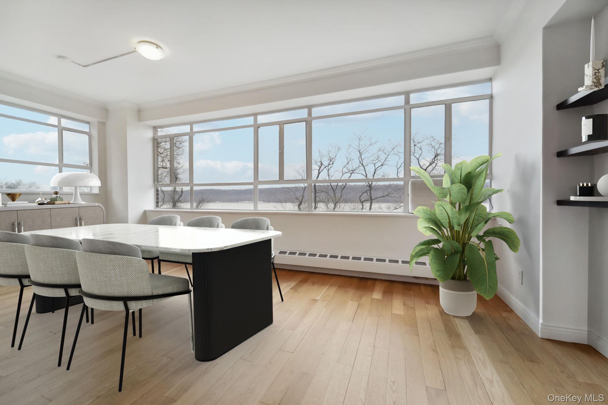 2727 Palisade Avenue, Unit 4H Bronx, NY 10463 - Photo 4 of 26 a kitchen with a table chairs and a potted plant