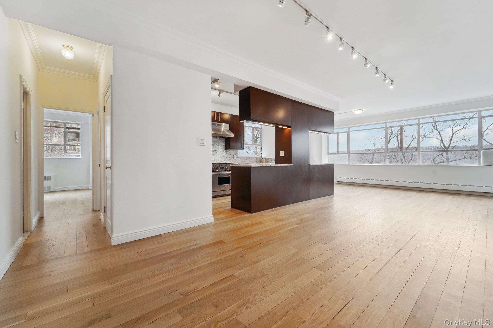 2727 Palisade Avenue, Unit 4H Bronx, NY 10463 - Photo 5 of 26 a view of a kitchen with furniture and wooden floor