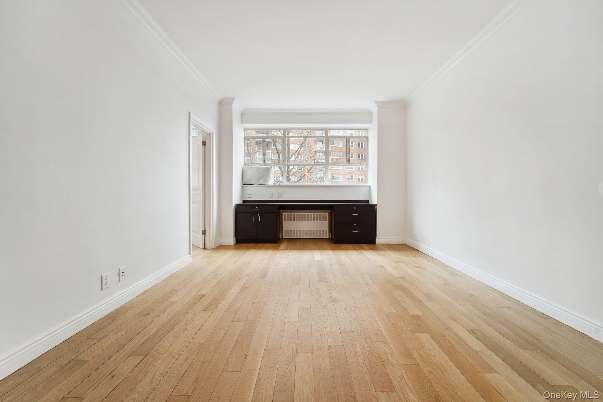 2727 Palisade Avenue, Unit 4H Bronx, NY 10463 - Photo 8 of 26 an empty room with wooden floor and a window