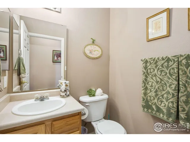 a bathroom with a sink toilet and a mirror