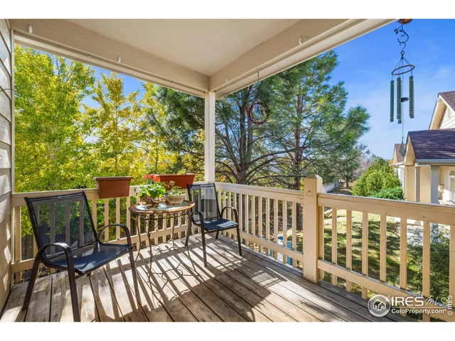 a view of a chairs and table in the balcony
