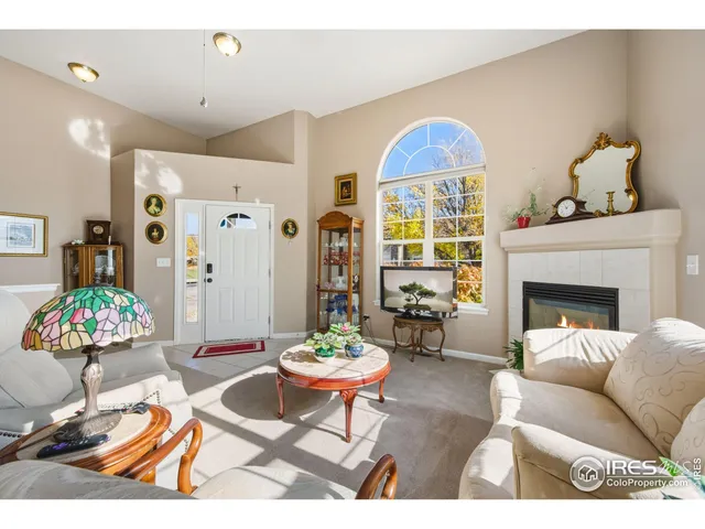 a living room with furniture a chandelier and a fireplace