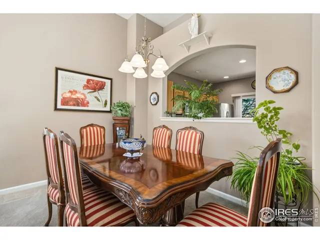 a view of a dining room with furniture and chandelier