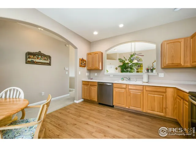 a kitchen with stainless steel appliances granite countertop a sink and a wooden cabinets